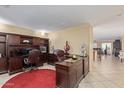 Spacious home office boasts custom built-ins, ample desk space, and neutral tile flooring at 3209 W Apollo Rd, Phoenix, AZ 85041