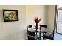 Bright dining area with glass table and four chairs at 3935 E Rough Rider Rd # 1191, Phoenix, AZ 85050