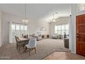 Bright dining room featuring a wood table and access to living area at 4220 E Thistle Landing Dr, Phoenix, AZ 85044