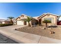 House exterior with desert landscaping and two-car garage at 4220 E Thistle Landing Dr, Phoenix, AZ 85044