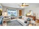 Bright living room with a cozy seating area, decorative fireplace, and views of the front yard at 4903 W Palm Ln, Phoenix, AZ 85035