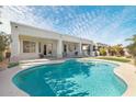 Relaxing pool area with covered patio and grassy area at 5613 N Laguna Ct, Litchfield Park, AZ 85340