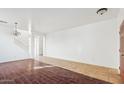 Bright living room with tile and hardwood flooring, and a staircase at 7411 W Alta Vista Rd, Laveen, AZ 85339