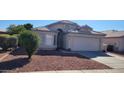 Front view of a single-story house with a two-car garage at 9215 W Sandra Ter, Peoria, AZ 85382