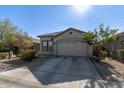 Single story home with a beige exterior and attached garage at 9519 W Trumbull Rd, Tolleson, AZ 85353