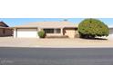 House front view, two-car garage, and well-maintained landscaping at 9714 W Edward Dr, Sun City, AZ 85351