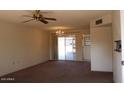 Bright living room with sliding glass doors leading to a patio at 9714 W Edward Dr, Sun City, AZ 85351