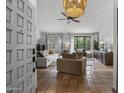 Inviting living room featuring light-colored walls, terracotta tile floors, plush seating, and natural light streaming through shuttered windows at 9837 E Pershing Ave, Scottsdale, AZ 85260