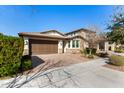 Two-story home with a brown garage door and well-maintained landscaping at 10012 E Tamery Ave, Mesa, AZ 85212