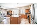 Open kitchen with island, stainless steel appliances, and wood cabinets at 1022 E Hiddenview Dr, Phoenix, AZ 85048