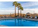Community pool offers mountain views, lounge seating, and tropical palm trees, perfect for relaxation at 10401 N Saguaro Blvd # 210, Fountain Hills, AZ 85268