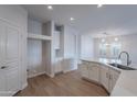 Modern kitchen with white cabinets, island, and quartz countertops at 10582 W Salter Dr, Peoria, AZ 85382