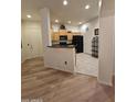 Open kitchen view, showcasing wood cabinets and black appliances, connecting seamlessly to other spaces at 14575 W Mountain View Blvd # 11210, Surprise, AZ 85374