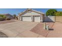 This home has a three-car garage with a long driveway and low maintenance desert landscaping at 1582 W Chicago St, Chandler, AZ 85224