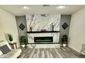 Beautiful living room featuring a fireplace, modern floors, and recessed lighting at 1708 W Harmont Dr, Phoenix, AZ 85021