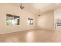 Bright dining room with tile floors and large windows at 210 W Yucca Ln, New River, AZ 85087