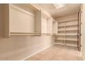 Large walk-in closet with hanging rods and shelving at 210 W Yucca Ln, New River, AZ 85087