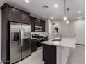 Modern kitchen features stainless steel appliances, dark cabinets, and a bright white countertop island at 2828 N Evergreen St, Buckeye, AZ 85396