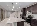 Open kitchen design featuring stainless steel appliances, a modern island, and pendant lighting at 2828 N Evergreen St, Buckeye, AZ 85396