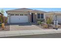 Single-story home with white exterior, brick accents, and a two-car garage at 31983 N 124Th Dr, Peoria, AZ 85383