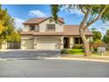 Two-story house with a three-car garage and manicured lawn at 7605 S 18Th Way, Phoenix, AZ 85042