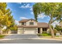 Two-story house with a three-car garage and landscaped yard at 7605 S 18Th Way, Phoenix, AZ 85042