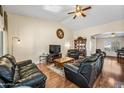 Cozy living room featuring hardwood floors, ceiling fan, and vaulted ceilings at 8479 E Sunrise Sky Dr, Gold Canyon, AZ 85118
