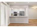 Modern kitchen featuring stainless steel appliances, sleek white cabinets, and quartz countertops at 9270 E Mission Ln # 117, Scottsdale, AZ 85258
