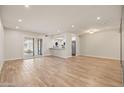 Bright, open-concept living room with wood-look tile flooring and access to outdoor space at 9270 E Mission Ln # 117, Scottsdale, AZ 85258