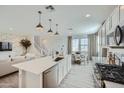 Open concept kitchen with island, white cabinets, and stainless steel appliances at 10144 E Ursula Ave, Mesa, AZ 85212