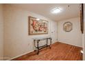 Entryway with wood floors, glass-top table, and artwork at 10330 W Thunderbird Blvd # A321, Sun City, AZ 85351