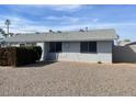 Rear view of the house showcasing a gravel backyard at 10365 W Pinehurst Dr, Sun City, AZ 85351