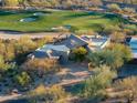 Modern home on a golf course with desert landscape at 10531 E Fernwood Ln, Scottsdale, AZ 85262