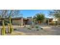 Contemporary home with desert landscaping and a two-car garage at 10531 E Fernwood Ln, Scottsdale, AZ 85262