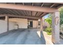 Tan home with covered parking, decorative bricks, and desert landscaping at 1245 E Avenida Hermosa --, Phoenix, AZ 85014