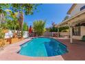 Backyard pool and shaded patio area offer an ideal space for outdoor enjoyment at 1450 W Sea Haze Dr, Gilbert, AZ 85233