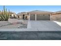 Single-story home with a two-car garage and desert landscaping at 15973 W Sheila Ln, Goodyear, AZ 85395