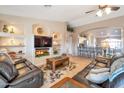 Open living space with a built-in entertainment center and a view into the kitchen at 15973 W Sheila Ln, Goodyear, AZ 85395