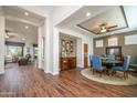 Bright dining area with hardwood floors and a round table for six at 16442 W Quarry Ct, Surprise, AZ 85374