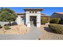 Welcoming front entry with decorative iron gate and drought-tolerant landscaping at 16442 W Quarry Ct, Surprise, AZ 85374