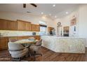 Spacious kitchen featuring ample cabinetry and an island with seating at 16442 W Quarry Ct, Surprise, AZ 85374