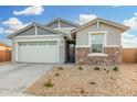 Charming one-story house with a two-car garage and stone accents at 19457 W Highland Ave, Litchfield Park, AZ 85340