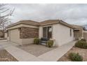 Charming house with stone veneer and a welcoming front porch at 19726 W Morning Glory St, Buckeye, AZ 85326