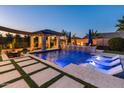 Luxury backyard oasis featuring a large pool, spa, and outdoor kitchen at 21622 E Via De Arboles --, Queen Creek, AZ 85142