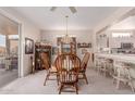 Cozy dining room featuring a wood table, upholstered chairs, and easy access to the kitchen at 22801 N Las Vegas Dr, Sun City West, AZ 85375