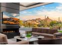 Modern living room features large windows offering views of the desert landscape at 28110 N 96Th Pl, Scottsdale, AZ 85262