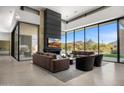 Spacious living room with sleek fireplace and scenic views at 28110 N 96Th Pl, Scottsdale, AZ 85262