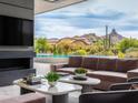 Cozy living room with fireplace, TV, comfortable seating and desert views at 28110 N 96Th Pl, Scottsdale, AZ 85262