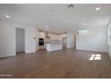 Bright and spacious living room with wood-look floors and open floor plan at 34690 N Ashwood Dr, San Tan Valley, AZ 85144