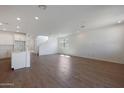 Open concept living room with wood-look floors and kitchen island view at 34690 N Ashwood Dr, San Tan Valley, AZ 85144